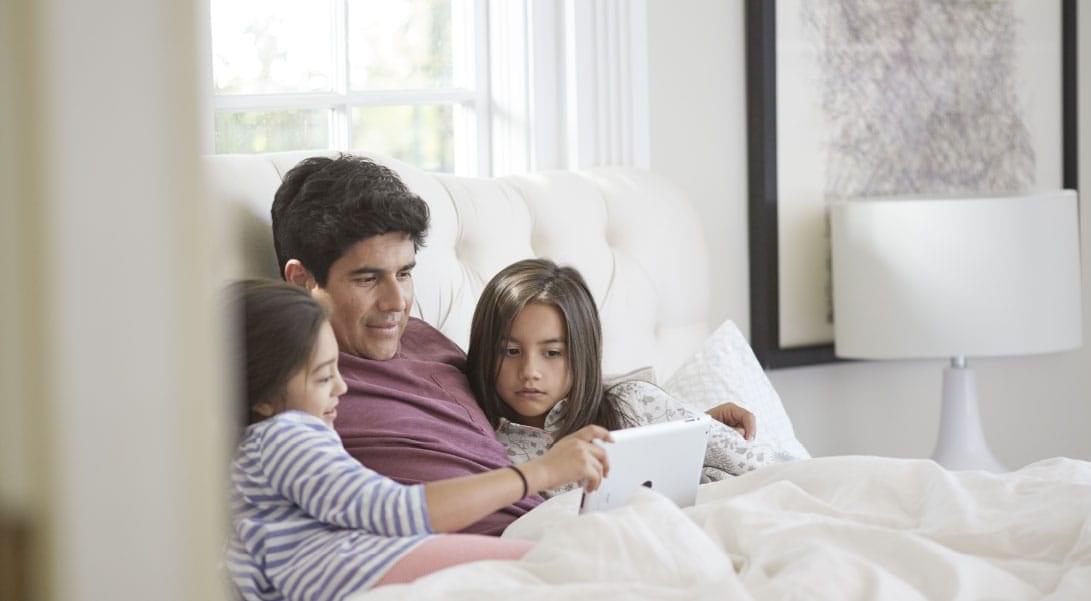 Cover Image - Family in bed watching iPad