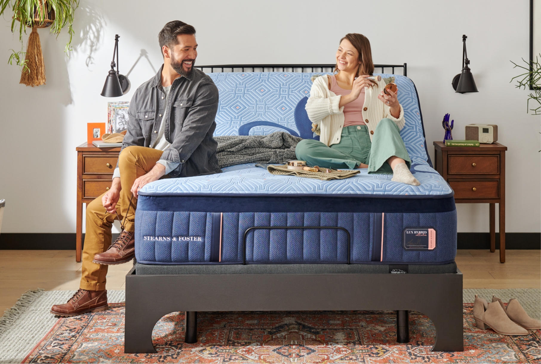 Couple talking on an adjustable Lux Hybrid mattress